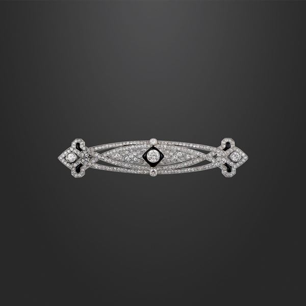 DIAMOND, ONYX AND PLATINUM BROOCH