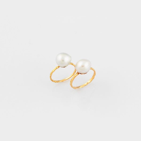 PAIR OF CULTURED PEARL AND GOLD RINGS