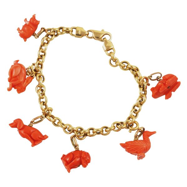 18KT GOLD AND CORAL "CHARMS" (slightly chipped) BRACELET