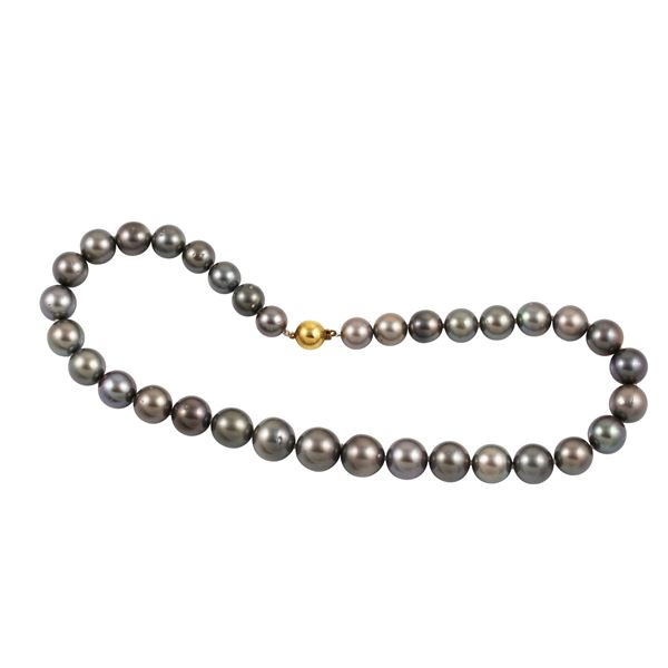 A TAHITI PEARL STREND WITH 9KT GOLD CLASP