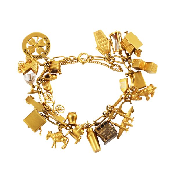 18KT GOLD BRACELET WITH TEN VARIOUS TITLE GOLD "CHARMS"