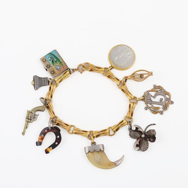 18KT GOLD BRACELET WITH GOLD AND SILVER CHARMS