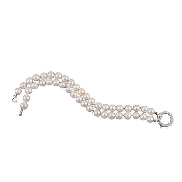 A TWO STRAND CULTURED PEARL BRACELET WITH 18KT GOLD AND DIAMOND CLASP