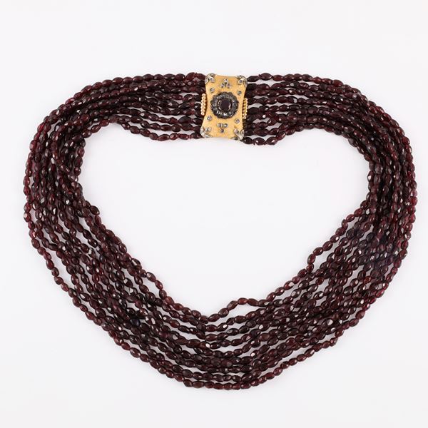 Necklace with nine strands of garnets and a gold and silver clasp with rose-cut diamond