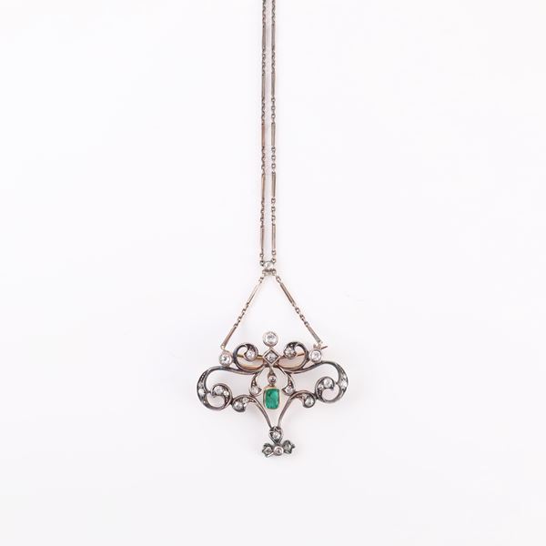 18KT AND SILVER PENDANT-BROOCH SET WITH EMERALD AND DIAMONDS. SILVER CHAIN