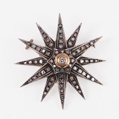 Spilla a forma di stella in oro 9KT e argento con brillante centrale e diamanti a rosa