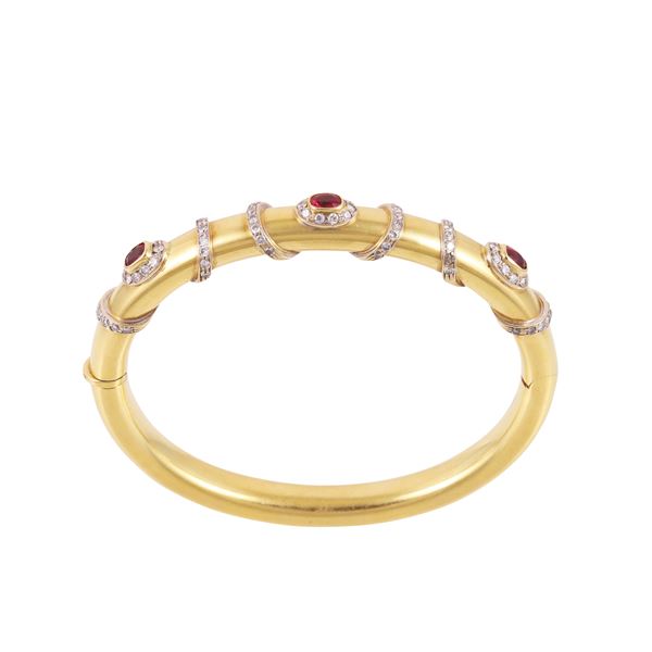 18KT GOLD BANGLE WITH RUBIES AND DIAMONDS (one missing), BY MICHELETTO