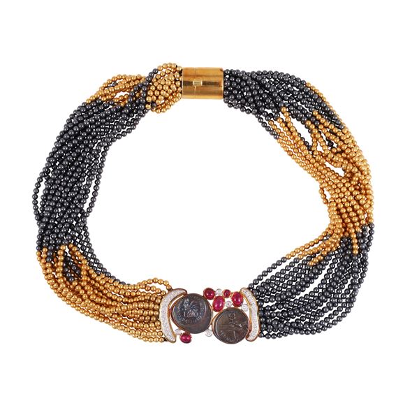 18KT GOLD NECKLACE WITH HEMATITE, CABOCHON-CUT RUBIES, DIAMONDS AND TWO REPRODUCTION ROMAN COINS, BY SCAVIA
