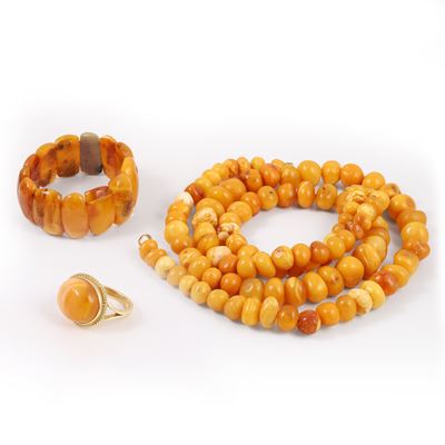 Gioielli in ambra, composizione di due collane, bracciale elastico e anello in oro giallo