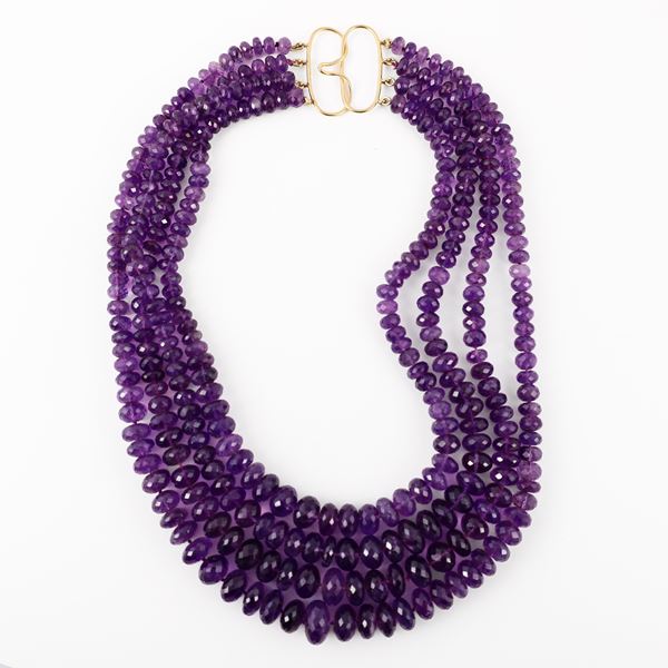 A FOUR-STRAND AMETHYST NECKLACE WITH AN 18KT GOLD CLASP
