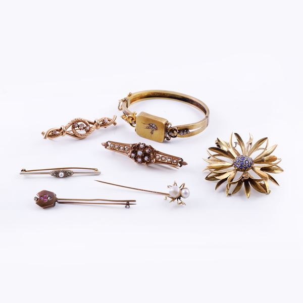 18KT GOLD LOT COMPRISING A BANGLE AND SIX BROOCHES