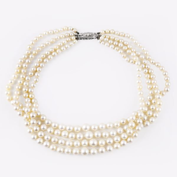 A FOUR-STRAND CULTURED PEARL NECKLACE WITH DIAMOND-SET 18KT GOLD CLASP