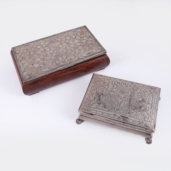 Two jewel boxes, one in 800/1000 silver with velvet-lined interior (approx. gross weight 200 g), the other in wood with lid clad in 800/1000 silver sheet (defects)