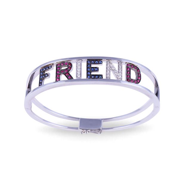 * 18KT GOLD BANGLE BEARING THE WORD "FRIENDS" SET WITH DIAMONDS, SAPPHIRES AND RUBIES